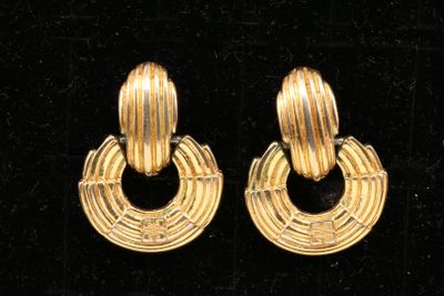 pair of gold tone earrings with circular hoops on black velvet