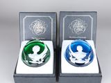 two glass figurines of a man and woman in a box