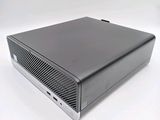 an image of a black computer sitting on top of a white surface