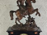 a statue of a man riding a horse with a flag on it