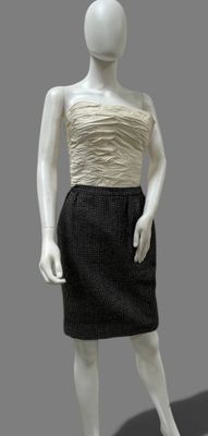 female mannequin wearing a black and white dress with a beige top