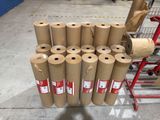 several rolls of brown paper are stacked on a cart in a warehouse