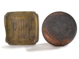 an old bronze coin and a small bronze box