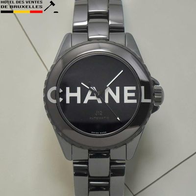 une montre noire sur laquelle est inscrit le mot « Chanel »