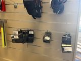 a wall with many different items on it in a store