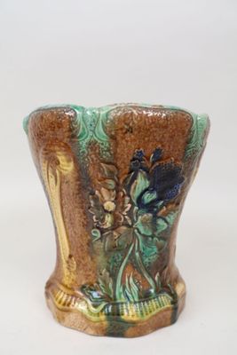 a vase with a bird on it sitting on a table