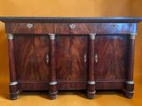 a wooden sideboard with three drawers and a marble top