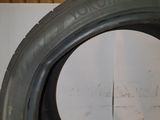 tires are lined up on a white surface with a hole in the middle of the tire