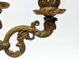 pair of antique brass candlesticks on a white background