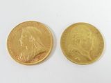 two gold coins on a white surface, one of which has a portrait of a woman