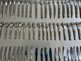 a lot of spoons and forks on a tray