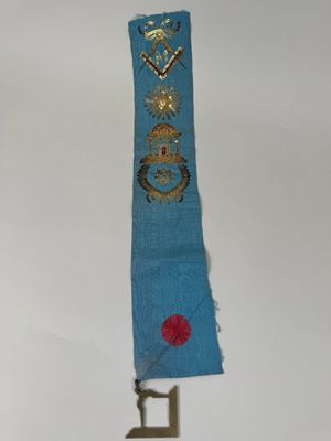 an image of a blue sash with a gold cross and a red rose on it
