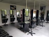 many chairs in the room with mirrors on the walls