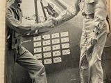 two men shaking hands in front of an airplane
