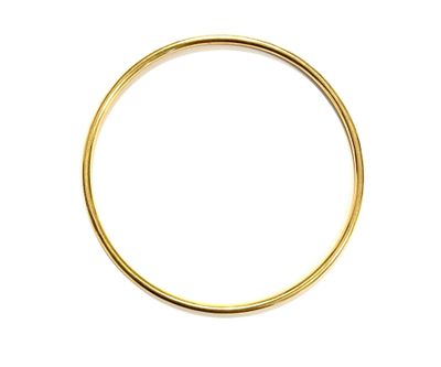 a close up of a gold ring on a white background