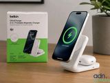 an image of a phone and charger on a table with a plant in the background