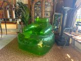 a green chair that is sitting in the middle of a living room