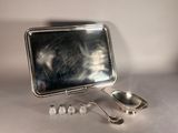 a mirror and spoons sitting on a table
