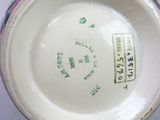 a white bowl with a blue and green design on it