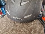a helmet sitting on top of a chair in a room