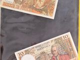two different bank notes in a bag on a table