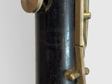 a close up of a black clarinet with a gold knob