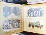 an open book with pictures of people and animals on it