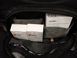 two boxes of cigarettes in the back pocket of a bag