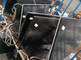 many televisions that are sitting on a cart in the warehouse
