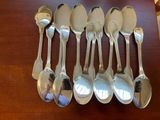 six spoons that are sitting on a table