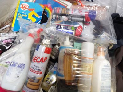 a pile of toiletries and cleaning products on the floor