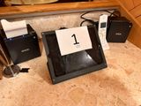 a tablet computer sitting on a counter next to other items