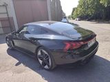 the rear end of a black sports car parked in a parking lot