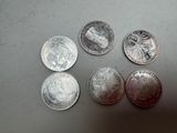 four quarters of silver coins sitting on top of a table