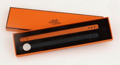 an orange box with a black pen inside of it on a white surface