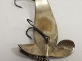 a metal spoon and spoon rest on a hook