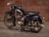a motorcycle that is parked in front of a brick wall