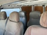 many seats in the back of a van that are dirty