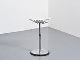 a white stool sitting in the corner of a room