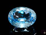 an image of a blue topazte gems on a black surface