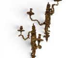 pair of antique brass wall sconces on a white background