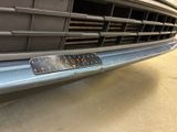 a close up of a car ' s grille with a number plate on it