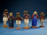 several figurines of people dressed in different outfits and hats