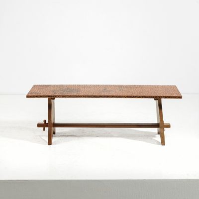 the table is made of wood and has a woven top
