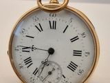 une montre de poche en or avec des chiffres romains sur le cadran
