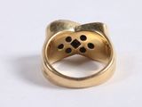 a close up of a gold ring with a paw print on it