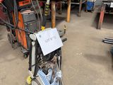 a small machine that is sitting in a garage