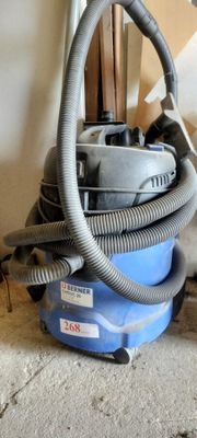 a vacuum that is sitting on the floor next to a wall