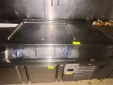 stainless steel counter top with three burners and two ovens
