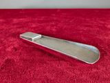 a silver tie bar sitting on a red blanket